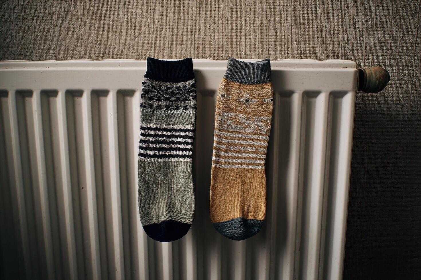 Cozy Winter Socks Drying on a Radiator A Symbol of Home Comfort and Warmth. Perfect for cold days, these stylish socks add a touch photo