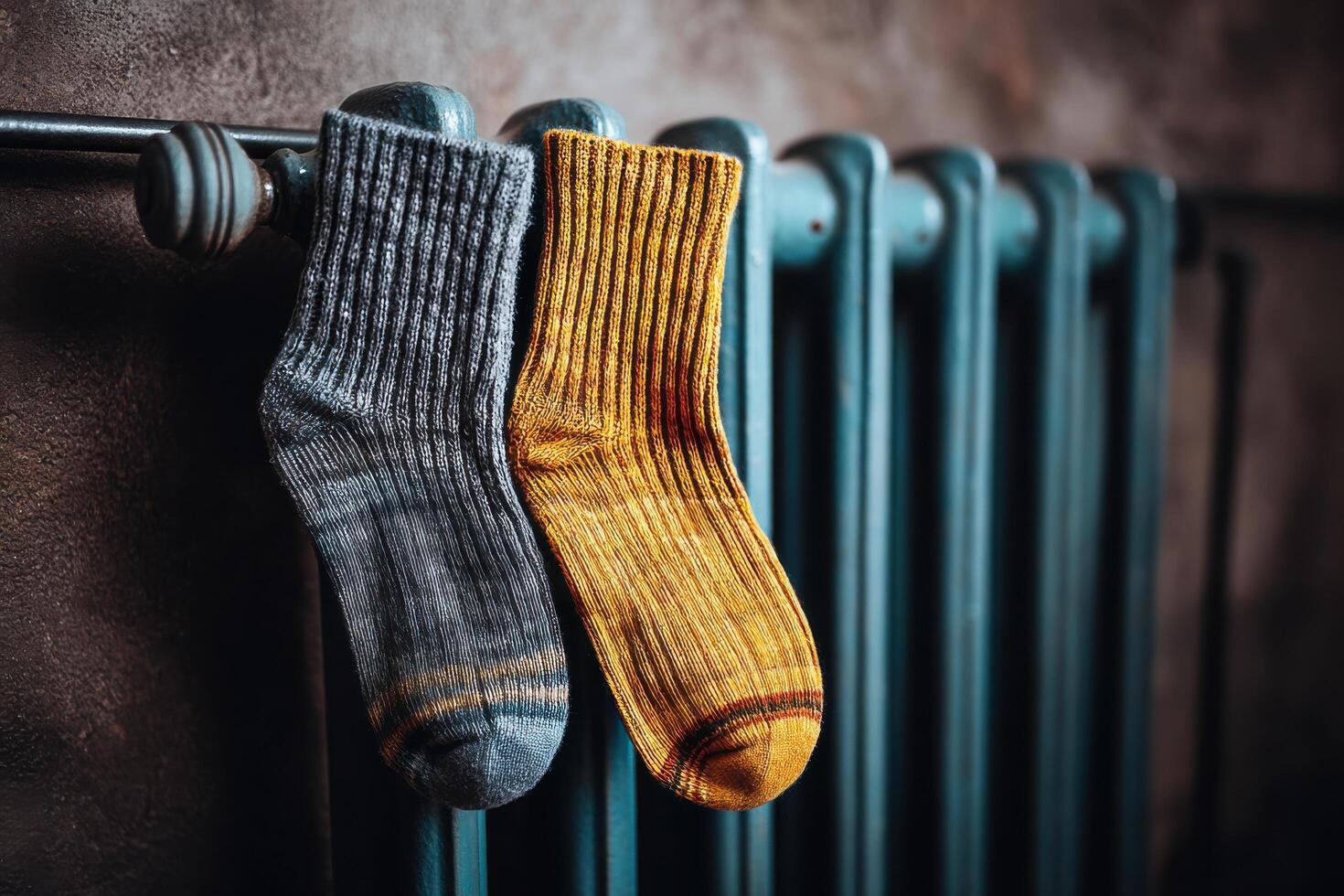 Cozy Knitted Socks Drying on a Vintage Radiator A Symbol of Warmth and Comfort for the Home. Perfect for cold winter days, these w photo