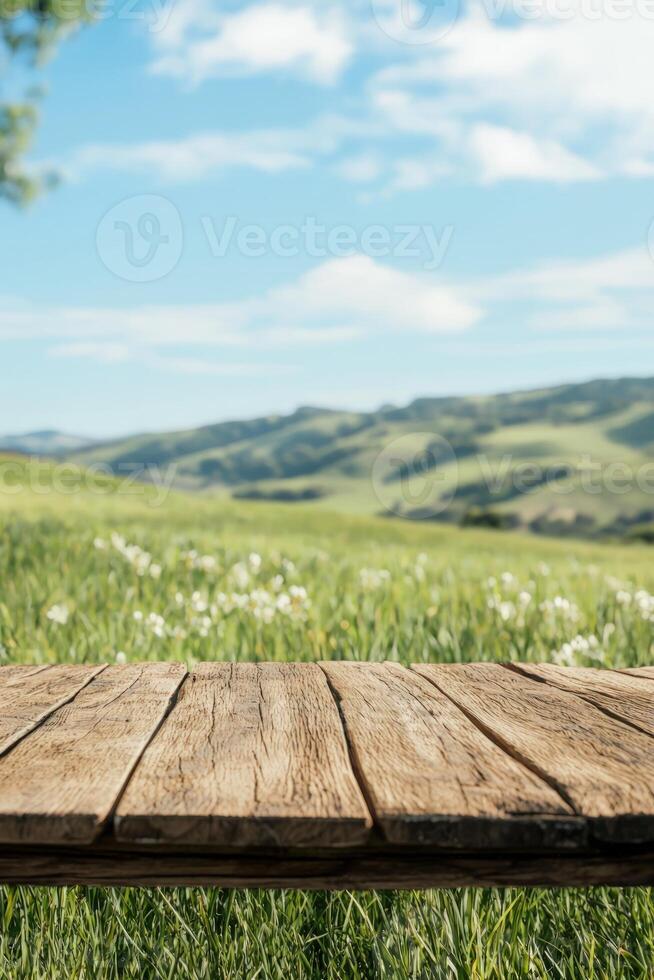 Wooden table in meadow, field with white flowers, blue sky in background use photo