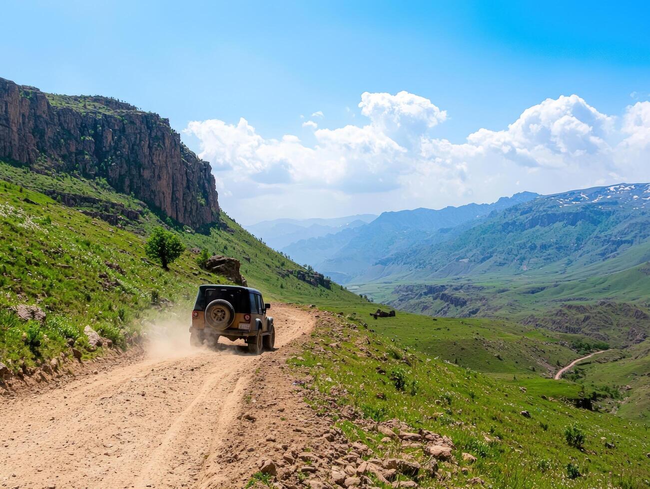 4x4 vehicle on dusty mountain road, scenic valley view, adventure travel photo