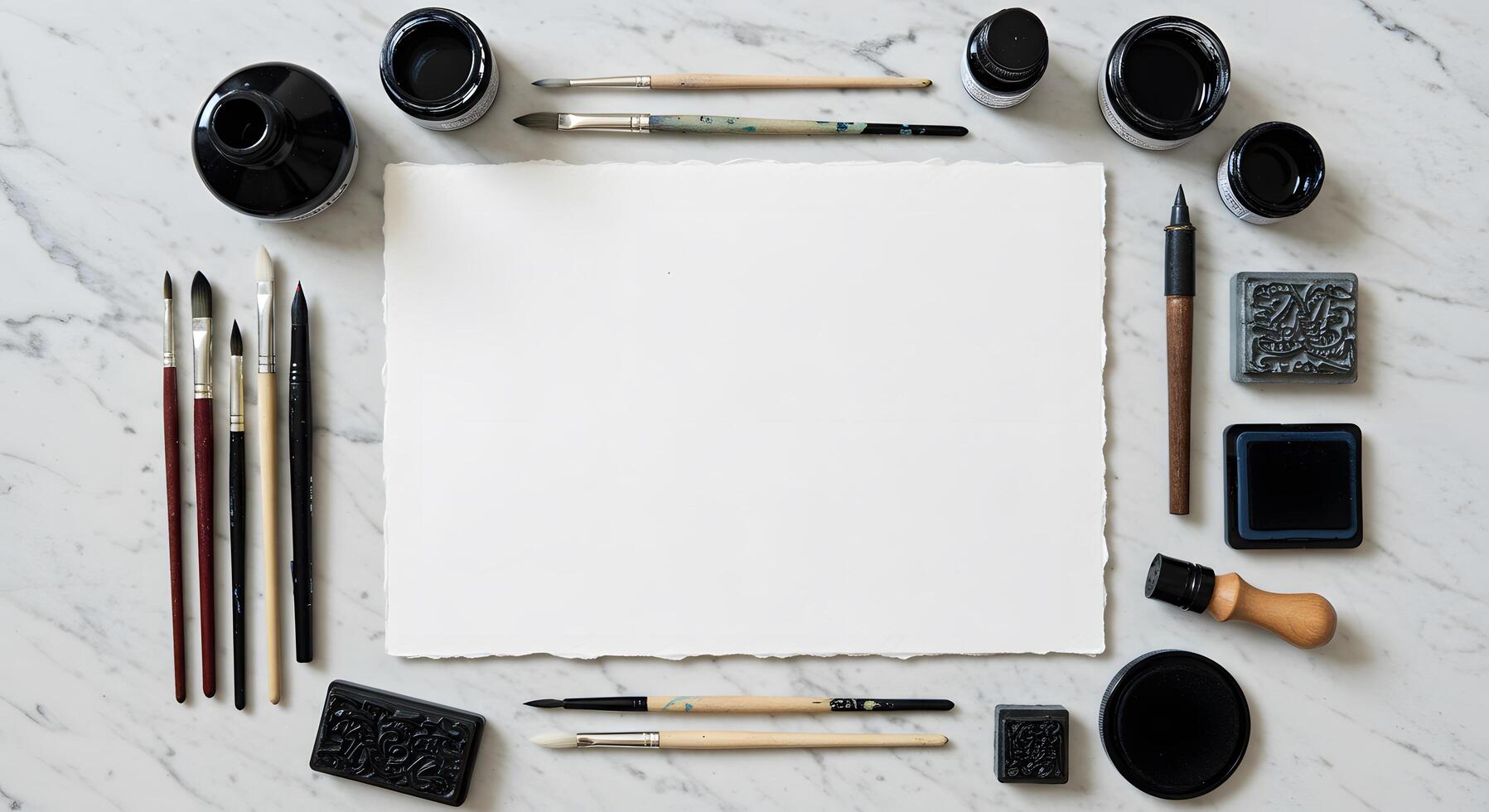 Artistic brushes, ink bottles, and blank handmade paper on marble photo