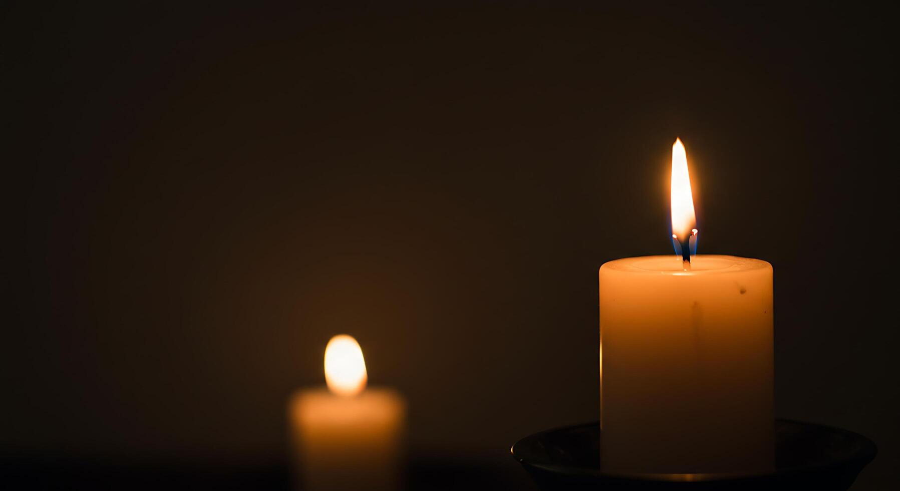 A Single Candlelight Illuminating the Darkness. A Symbol of Hope and Remembrance photo
