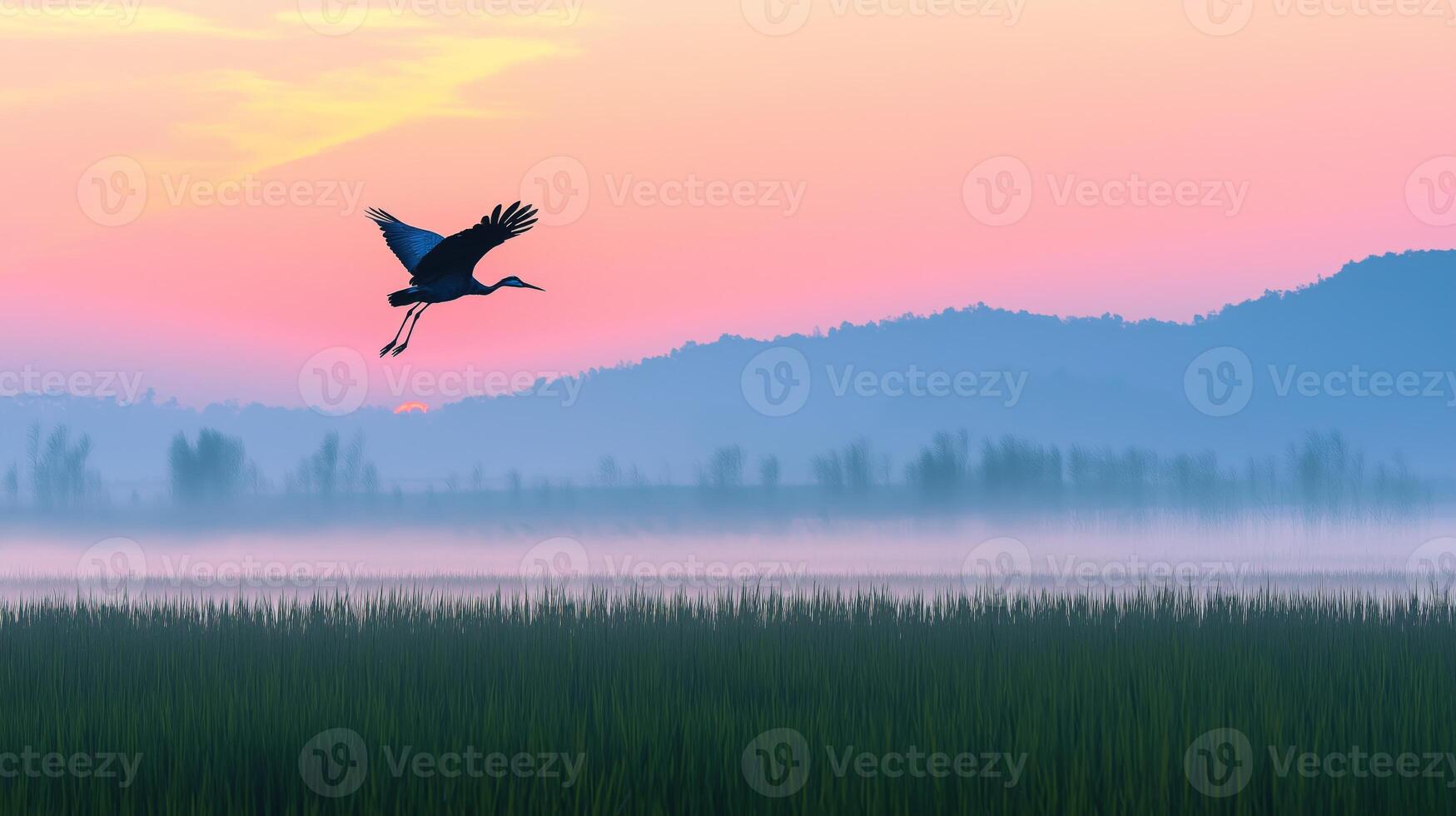 Cranes take flight over a serene wetland at dawn, surrounded by misty hills and sunrise colors. photo