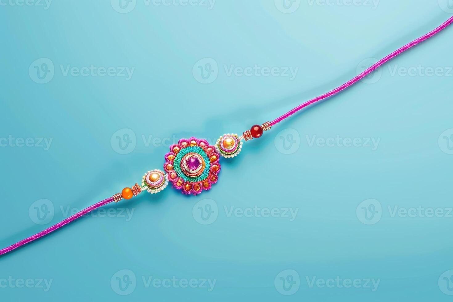 A pink rakhi with a colorful design photo