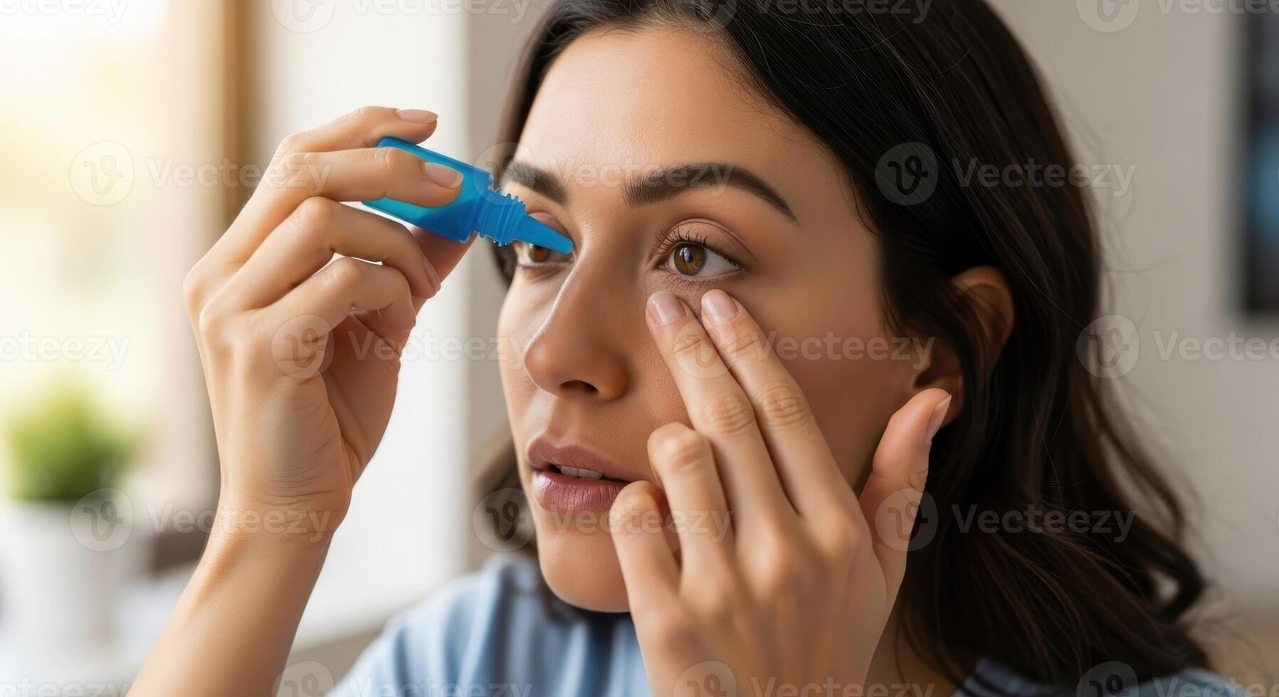 Young woman applying eye drops to her eye for vision care and health treatment photo