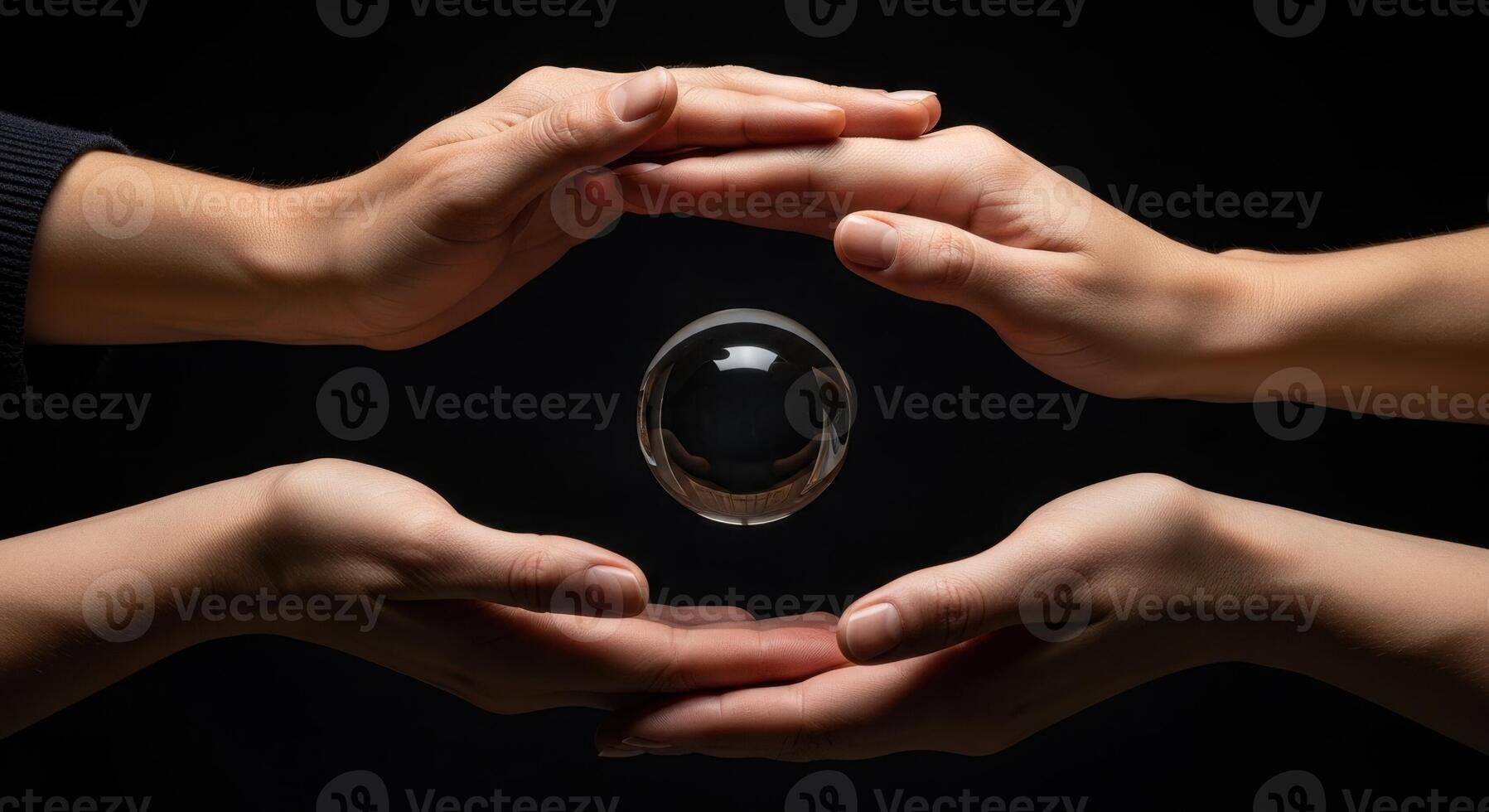 Hands surrounding a levitating clear glass sphere symbolizing future and protection photo