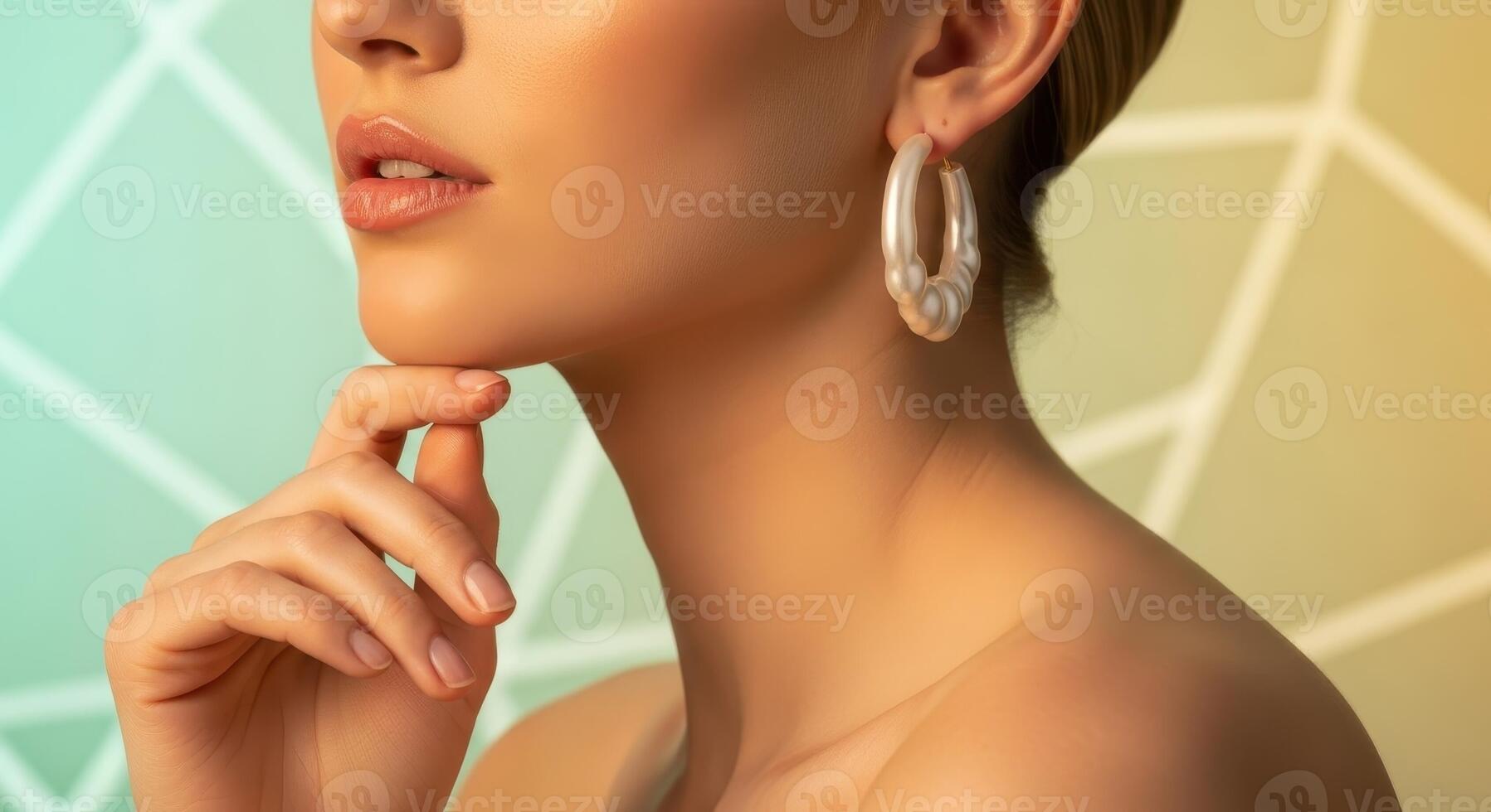 Elegant woman with pearl earring and bare shoulder, showcasing beauty and skincare photo