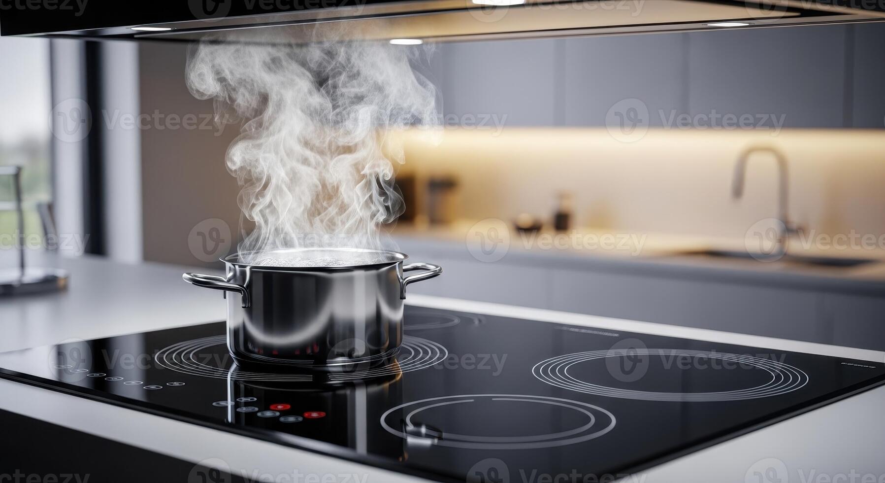 Stainless steel pot with steam on a modern induction cooktop in a contemporary kitchen photo