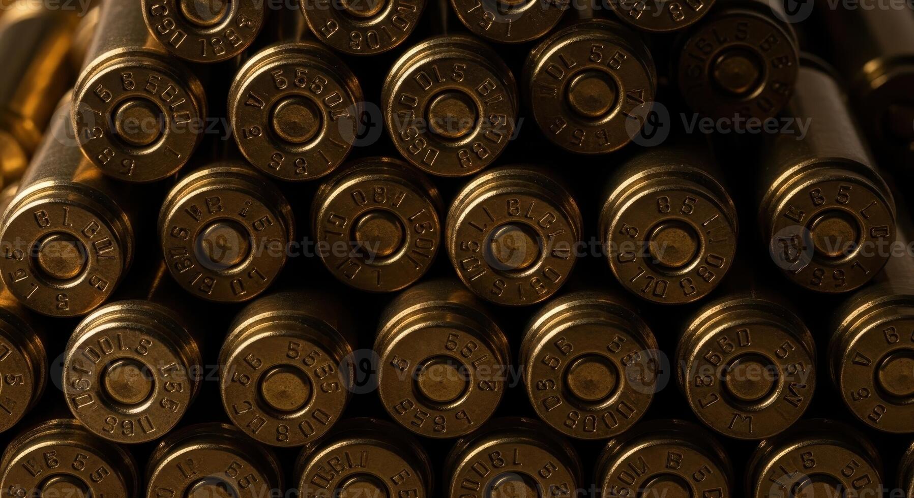 Close up of stacked brass bullet casings showing detailed markings on the base of each cartridge photo