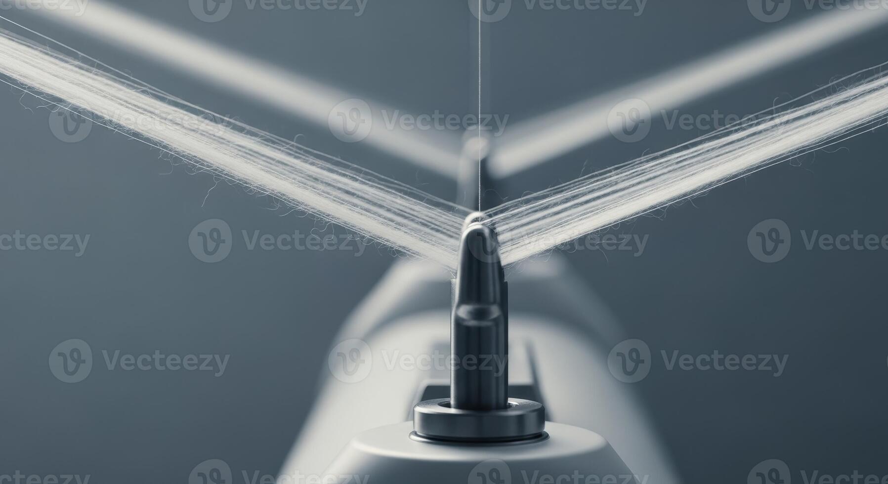 Close up of white textile thread on industrial spinning machinery in a factory photo