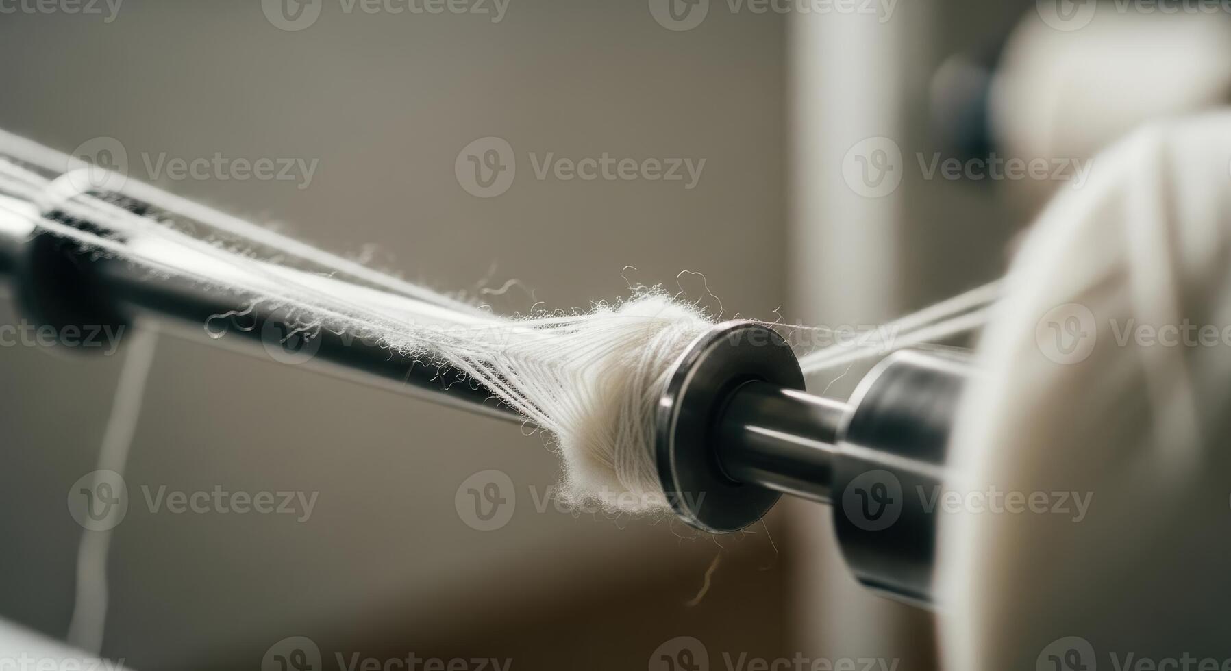 White yarn being wound on a textile machine in a factory production process photo