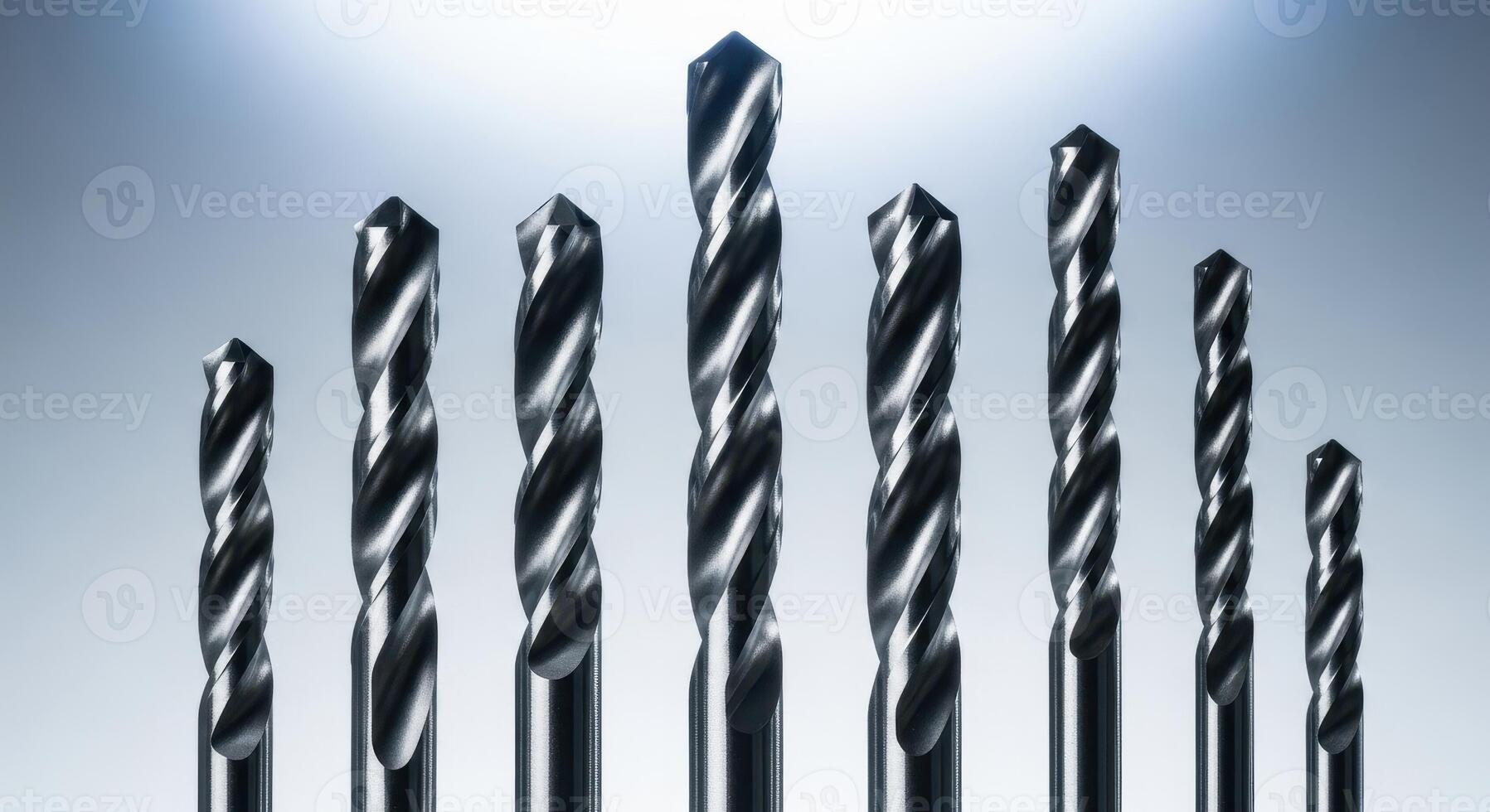 Set of shiny metal drill bits of various sizes for industrial and construction work photo