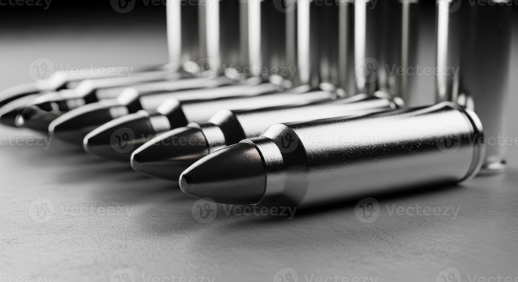 Close up view of metallic bullets and ammunition cartridges arranged on a dark surface photo