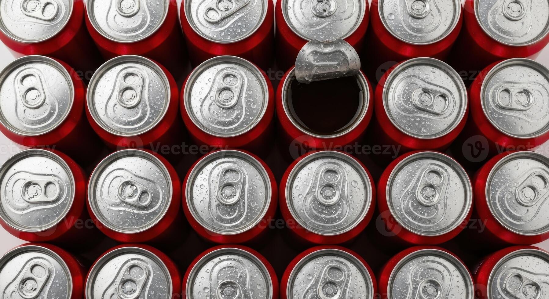 Top view of red soda cans with one open, showing cold refreshing beverages and condensation photo