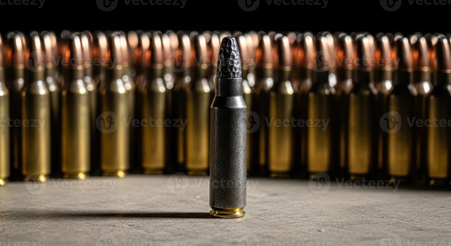 A distinct black bullet standing in front of a row of many golden bullets photo