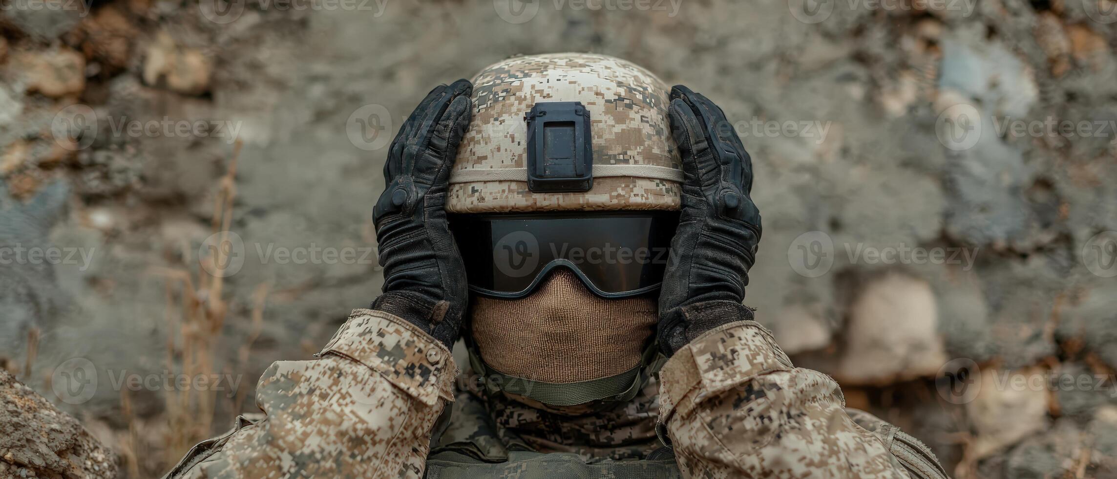 Soldier in camouflage with hands on helmet, war concept photo