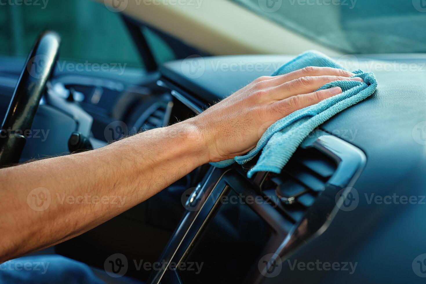 Hand Cleaning Car with Microfiber Cloth photo