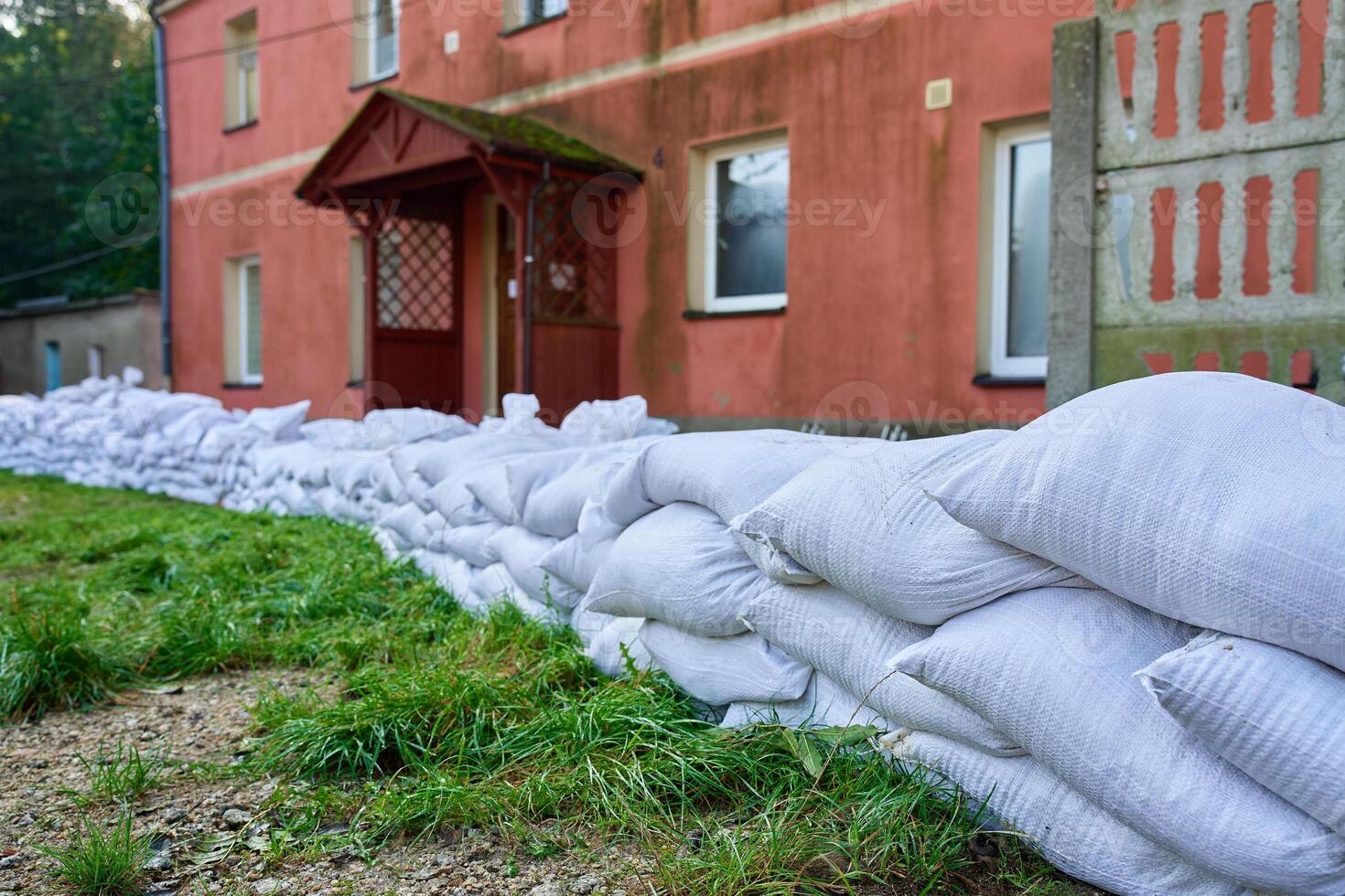 Sandbags stacked near house to protect from flooding photo