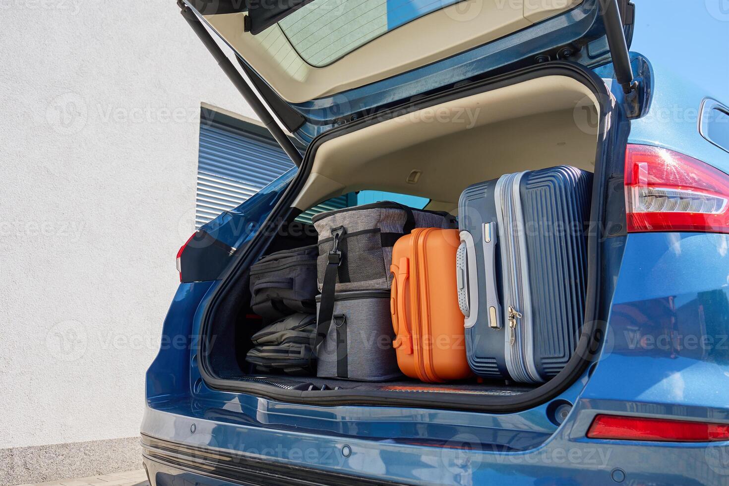 Car full of suitcases and travel bags ready for relocation or road trip photo