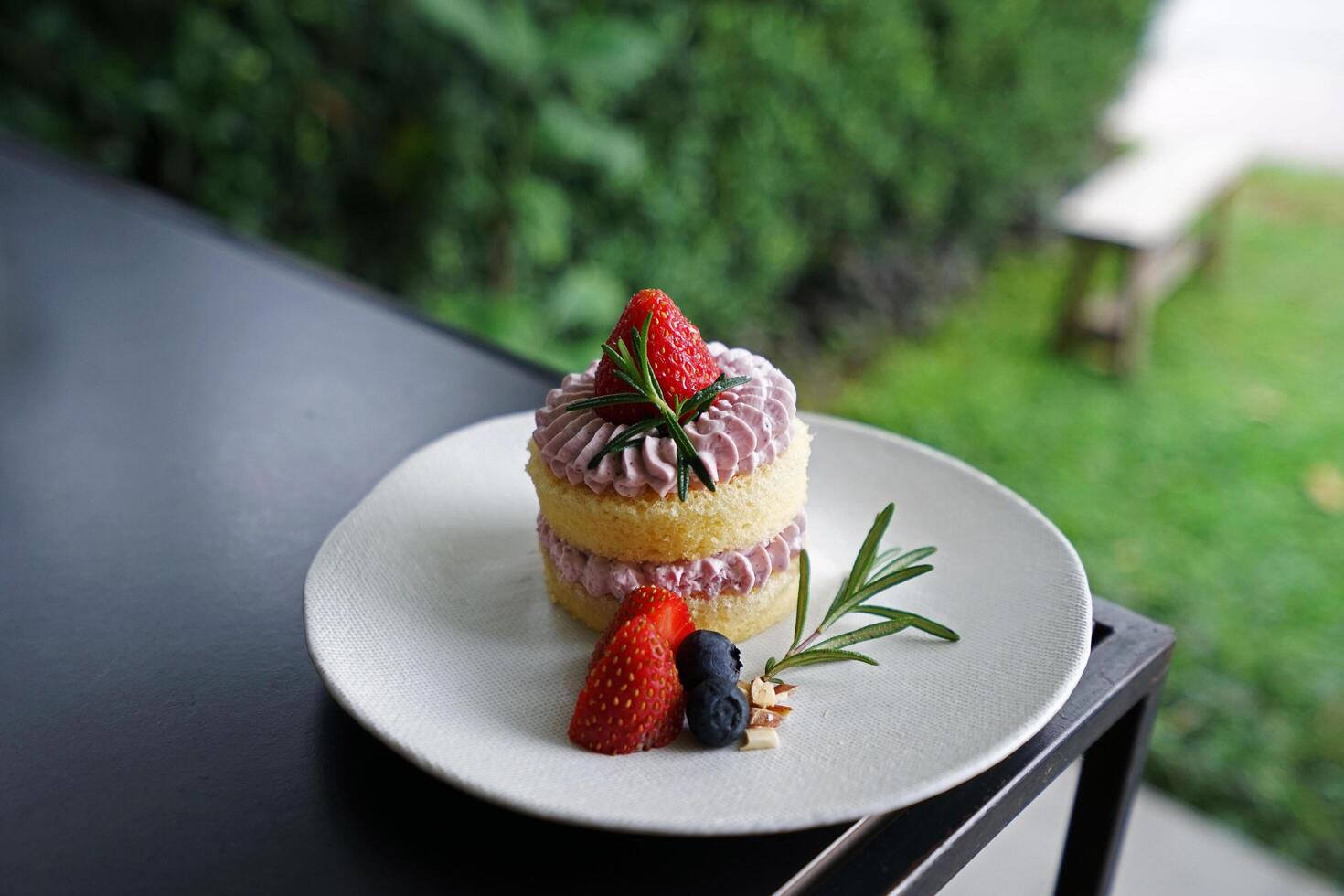 Close up plate of Raspberry shortcake decorated with fresh strawberry photo