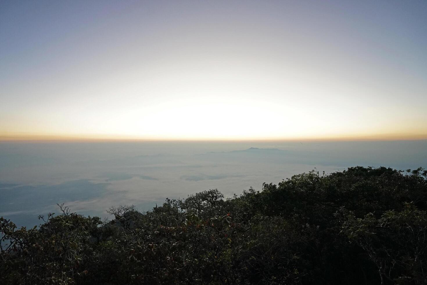 Sunset view on top of natural landscape of green hill peak with cloudscape photo