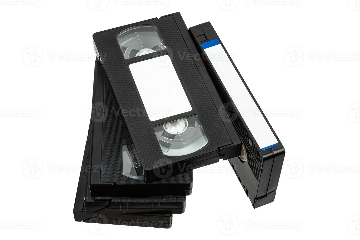 Stack of vintage VHS cassettes with blank white labels, arranged on white background photo