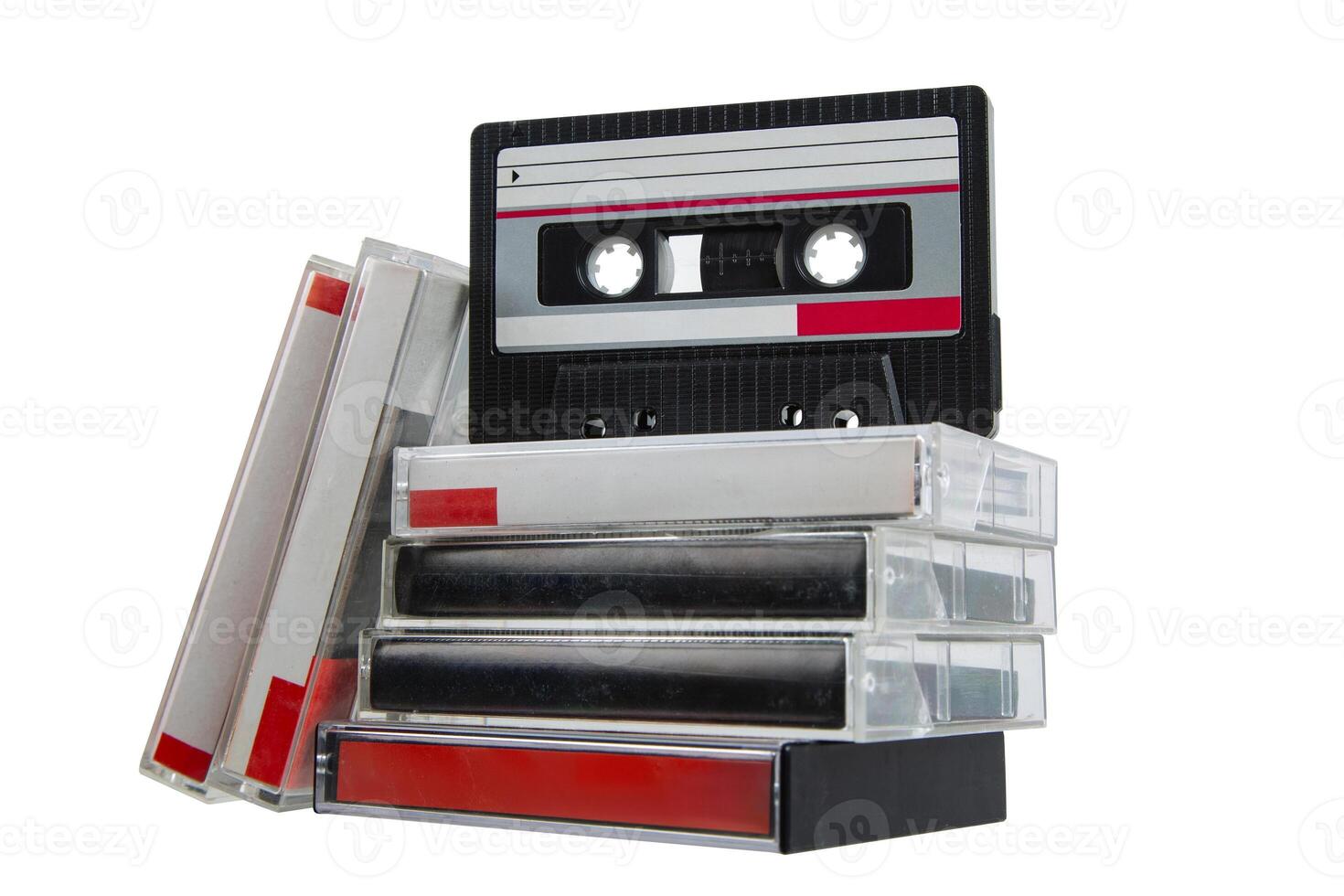 Retro audio cassette and stack of cases with red labels isolated on white back photo