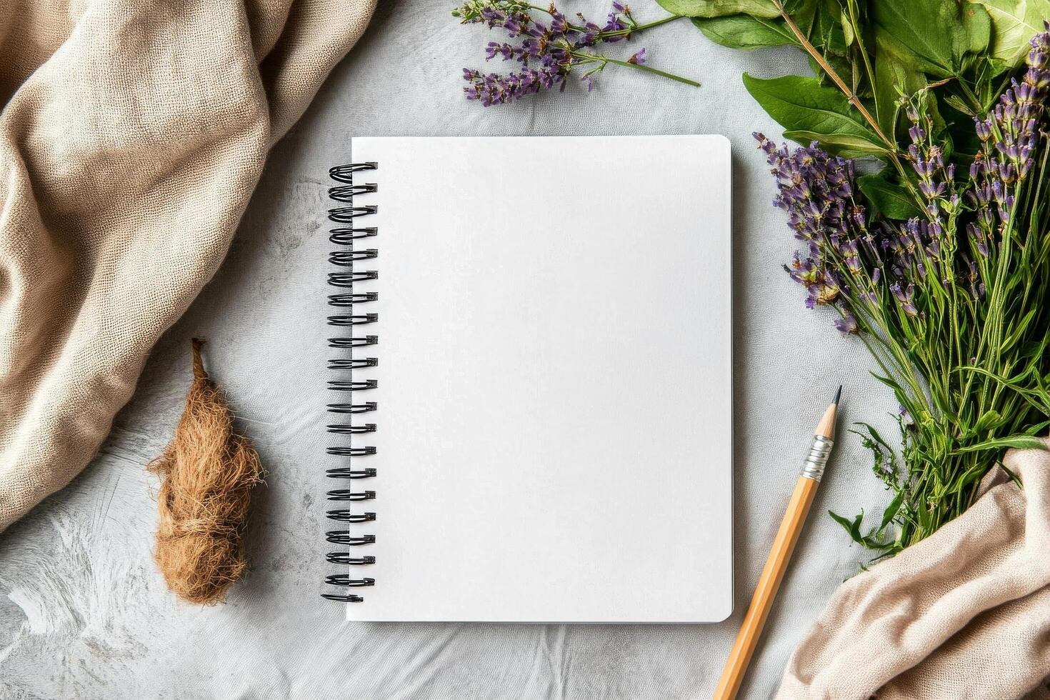 Blank Notebook With Pencil and Fresh Herbs on Textured Surface in a Bright Natural Setting photo