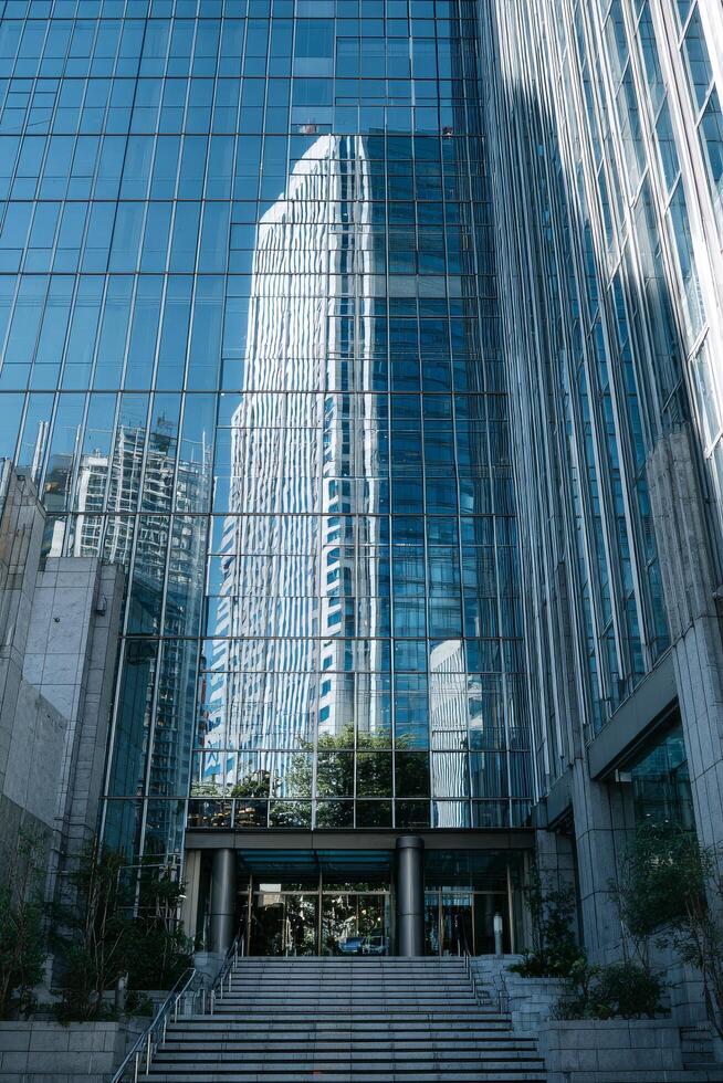 Reflection of Modern Skyscrapers in Glass Buildings During Daylight in an Urban Area. photo