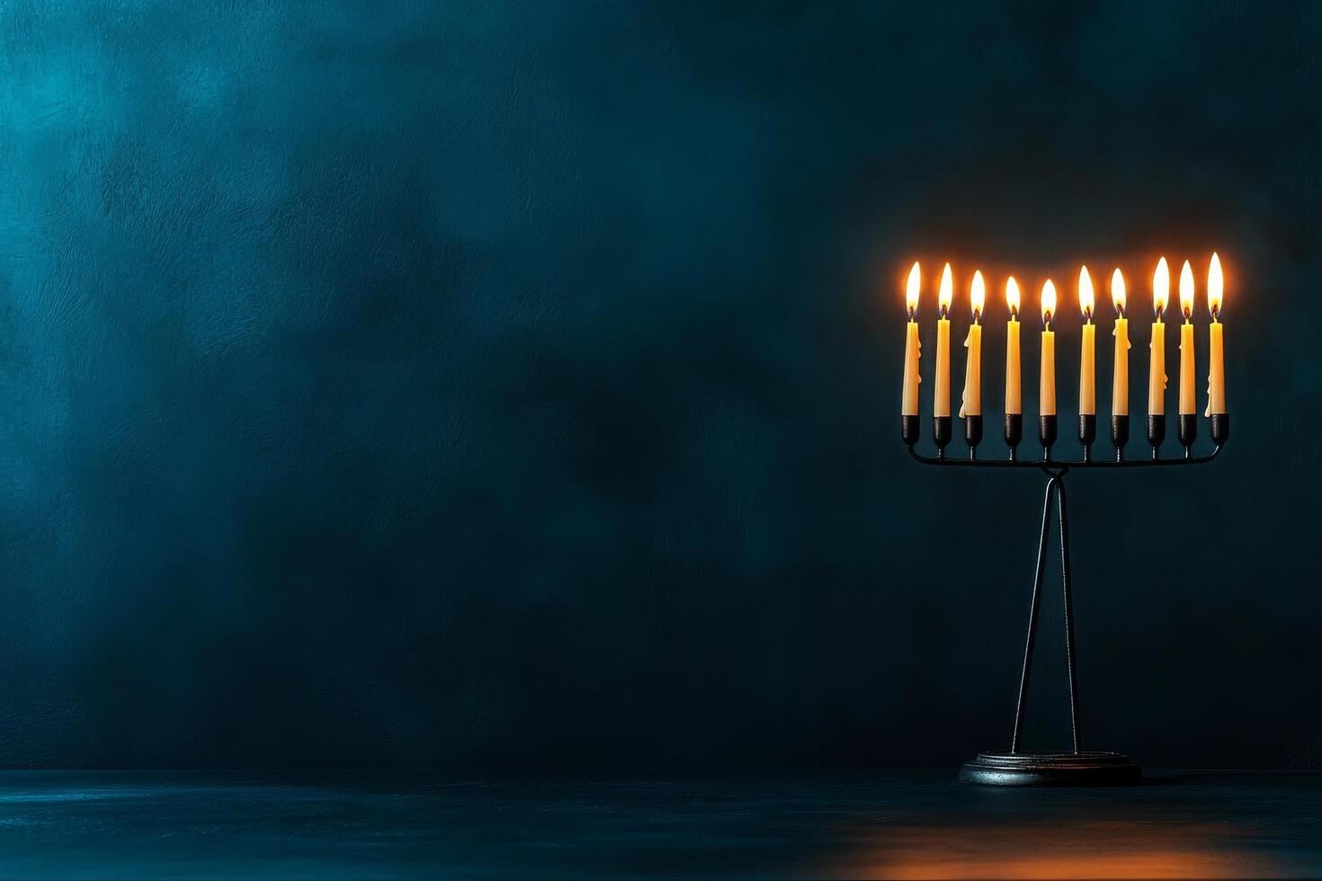 Menorah Illuminated With Candles on a Dark Blue Background During a Festive Celebration photo