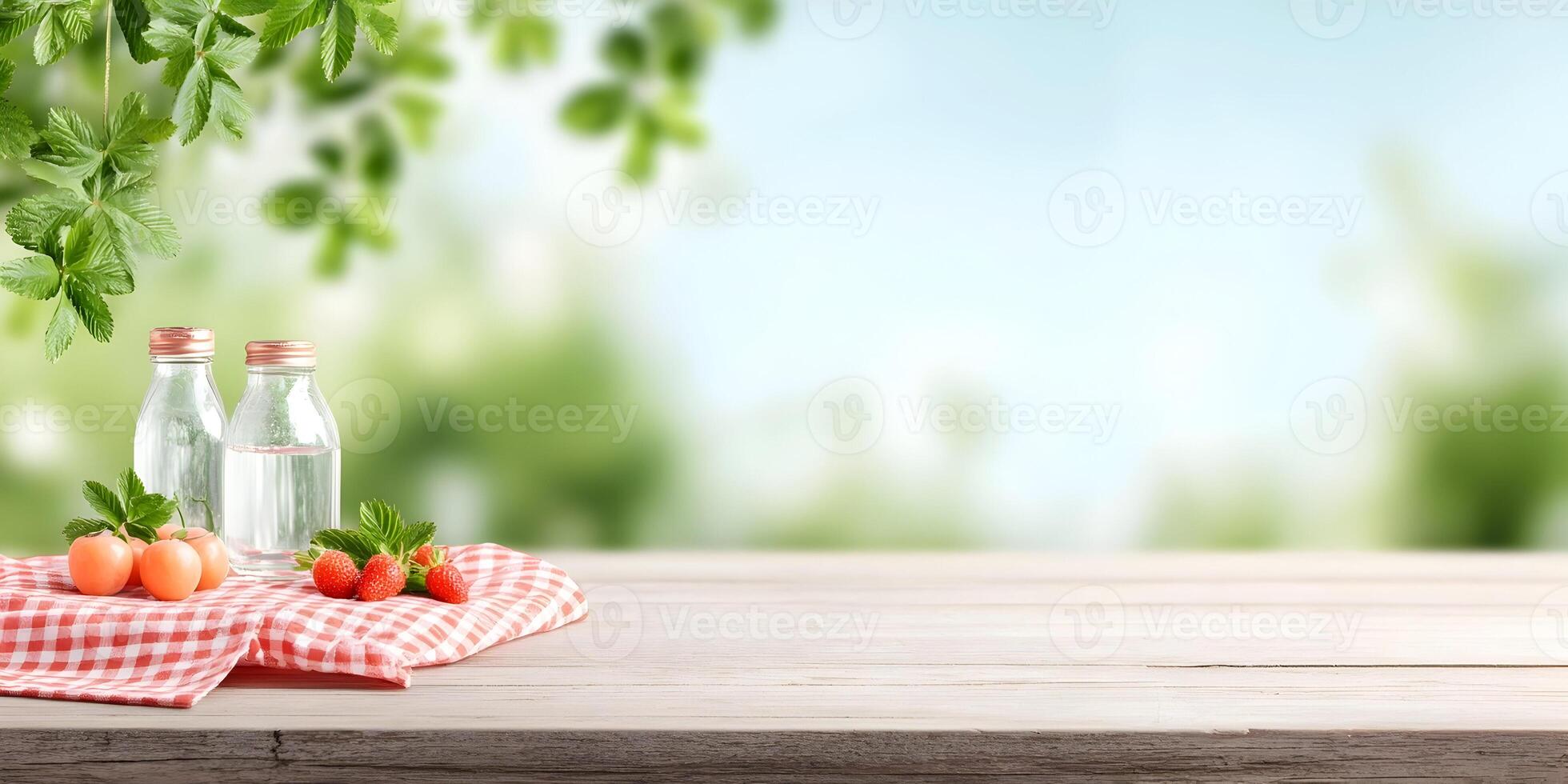 Summer Picnic Table Setting with Strawberries and Two Glass Bottles photo