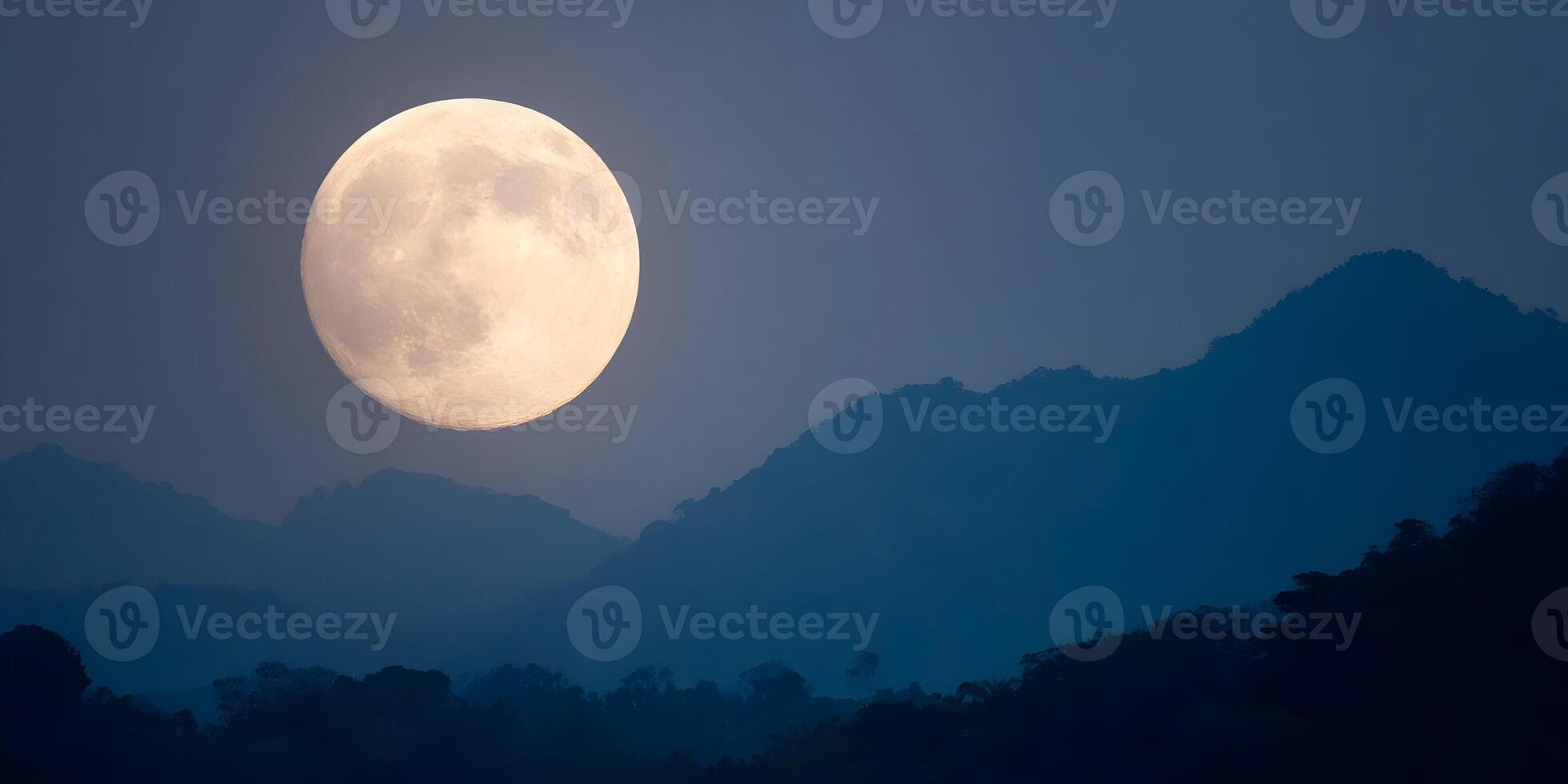 Large Full Moon over Silhouetted Mountains and Forest Night Sky Scene photo