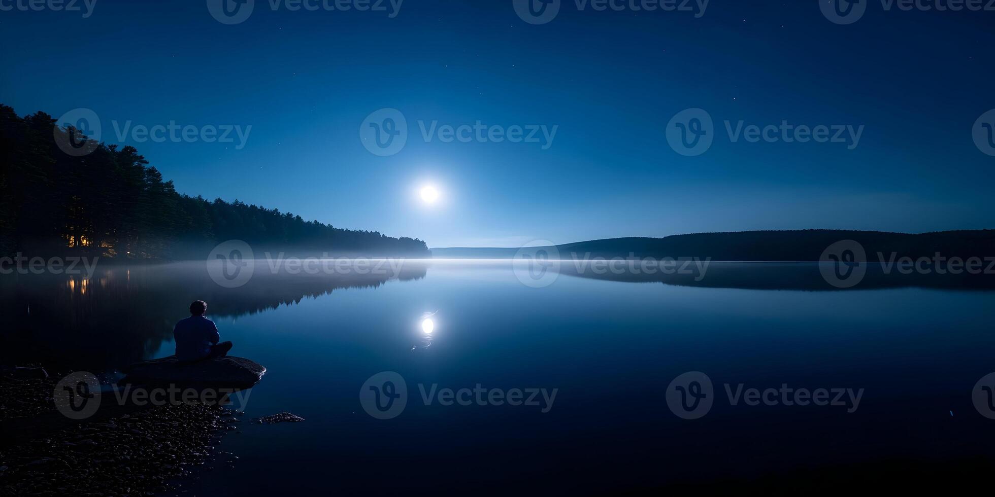 Person Silhouetted Sitting Lake Night Moon Calm Peaceful Scene photo