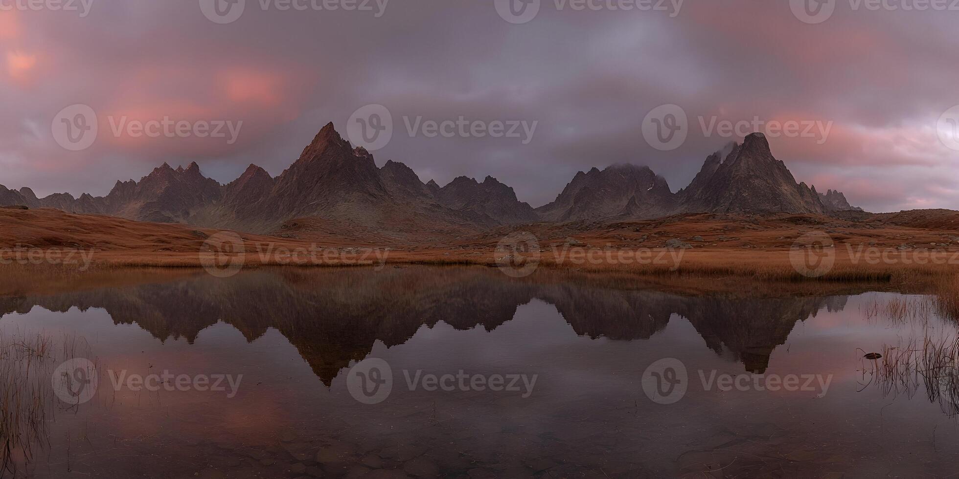 the mountains are reflected in a lake at sunset photo