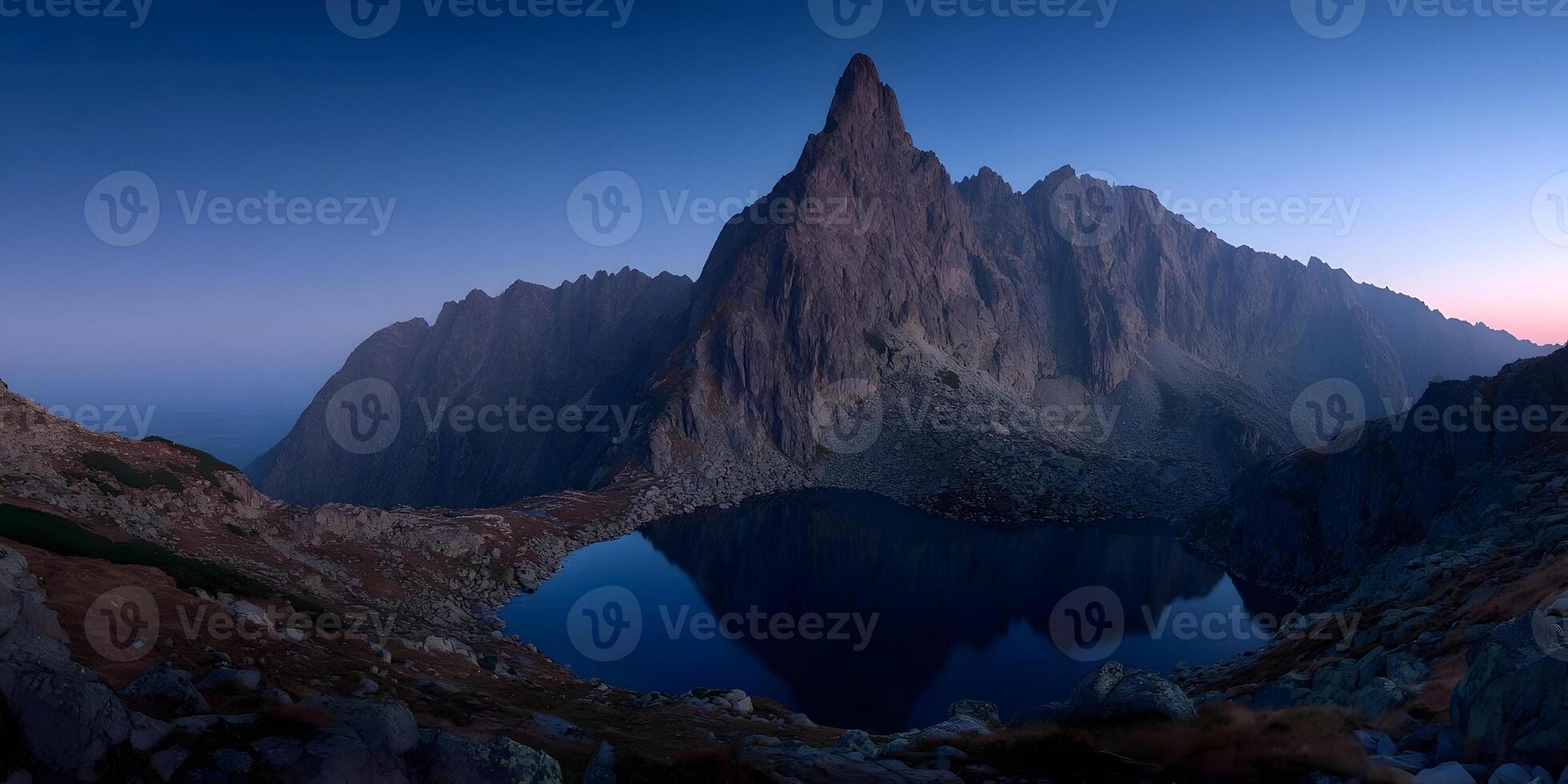 a mountain lake and mountain range at dusk photo