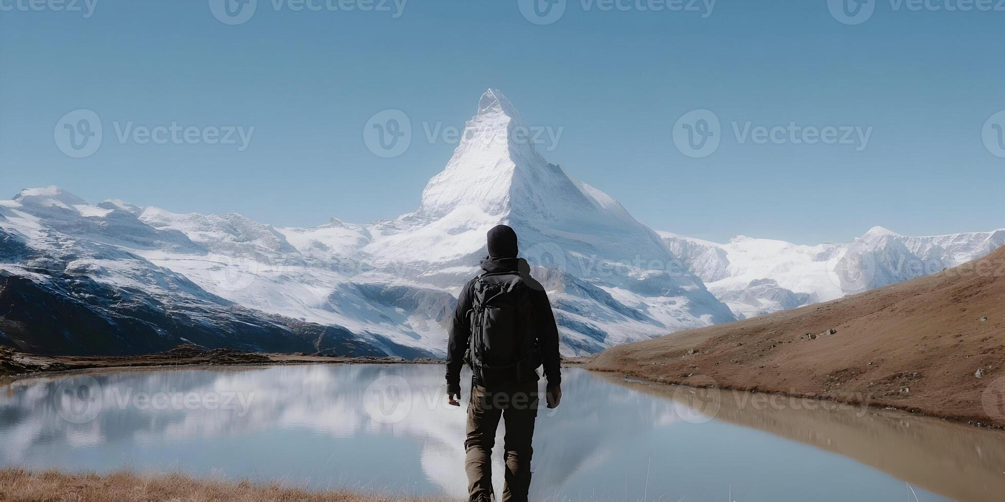 Man with Backpack Facing Majestic Swiss Alps Matterhorn Mountain Lake Landscape photo