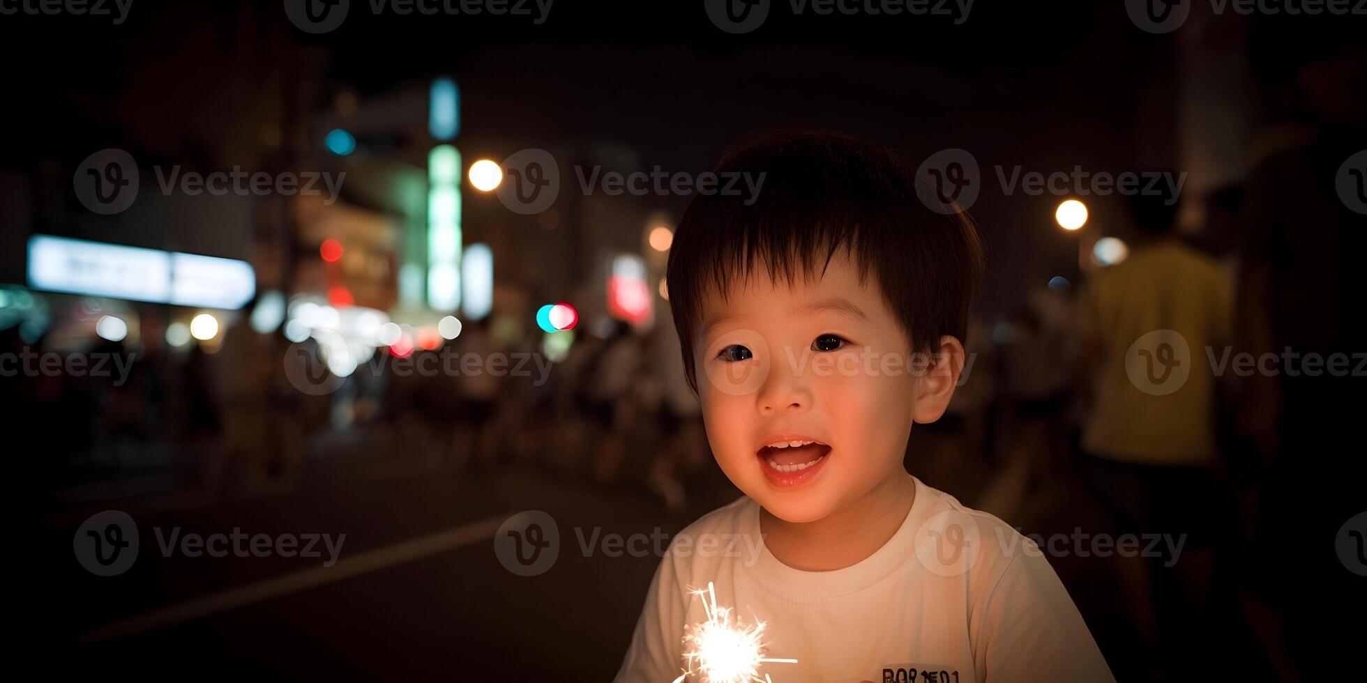 Happy Toddler Boy Holding Sparklers at Night City Background photo