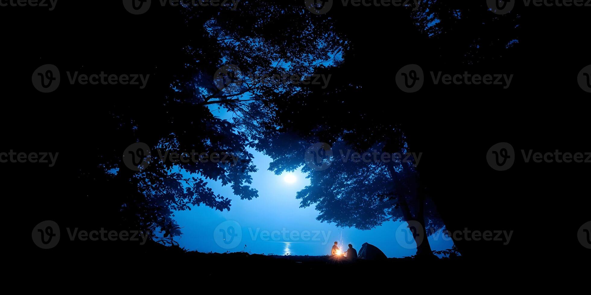 Silhouette of Two Campers by a Lake at Night Under the Moonlight photo