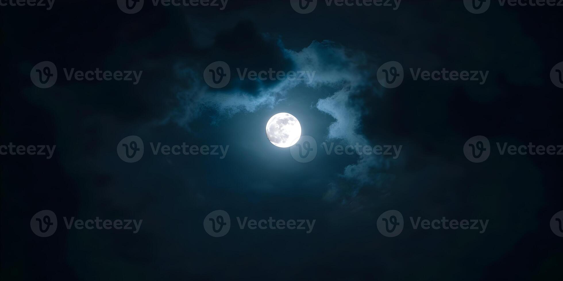 the moon is seen in the dark sky with clouds photo