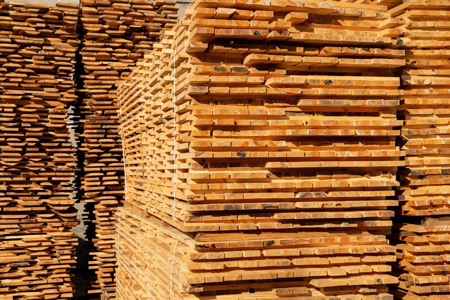 Many boards on the sawmill. Production of boards. Storage of wooden boards in production photo