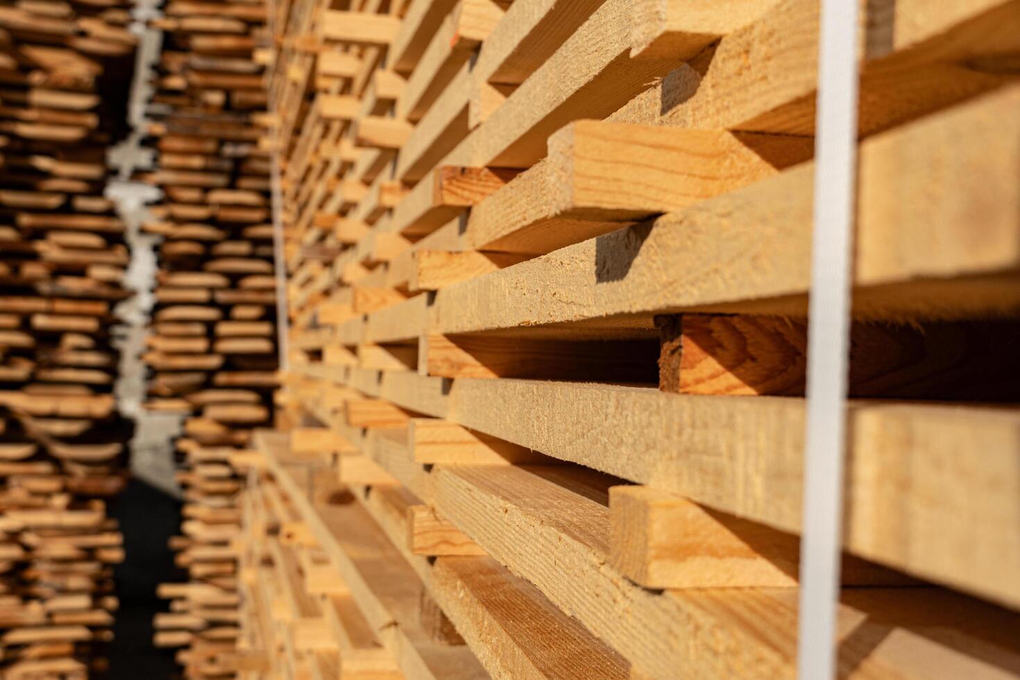 Piles of wooden boards in the sawmill. Air drying of wood photo
