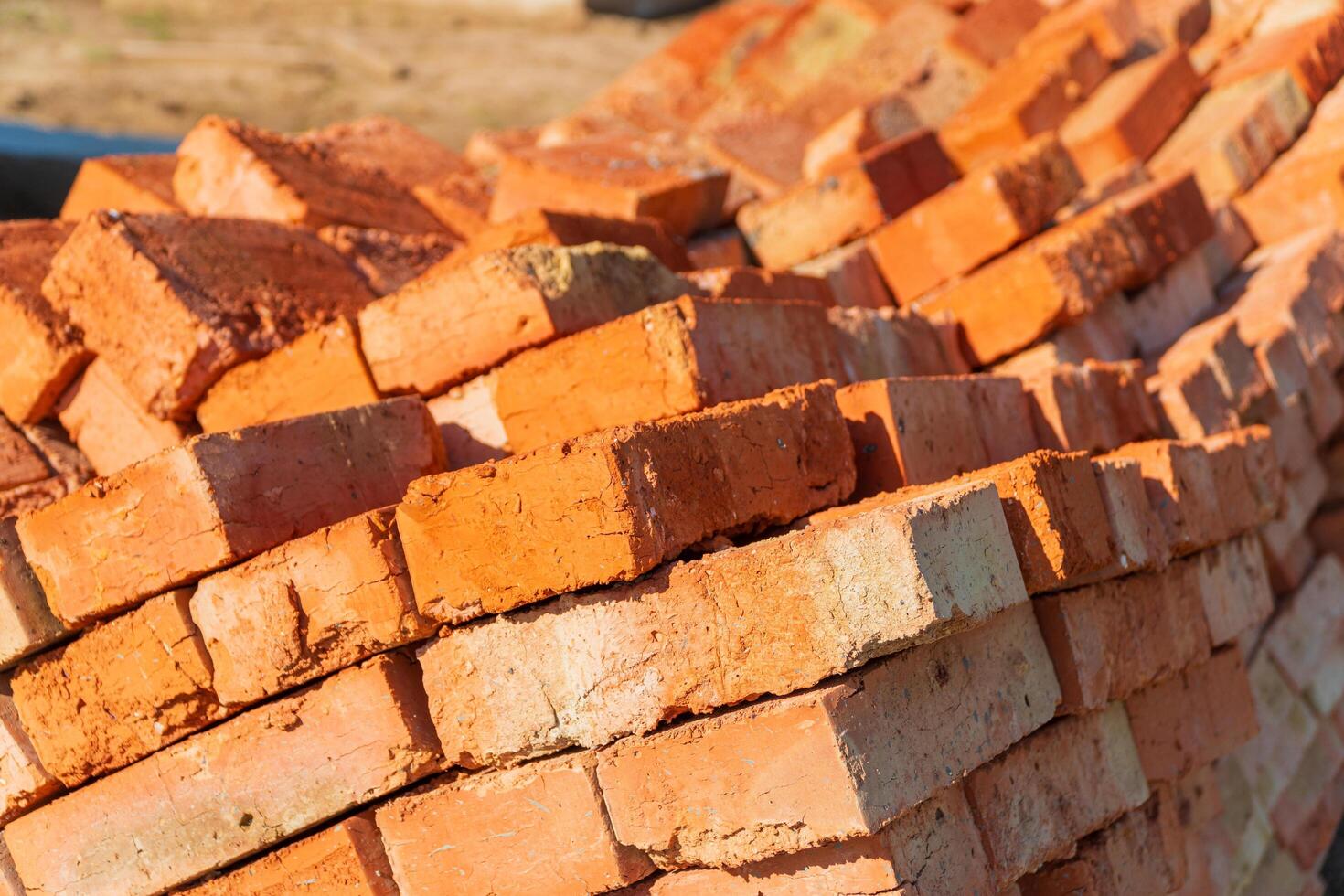 The red bricks is stacked on the construction site. The red bricks is used in the construction of houses. Material for construction photo