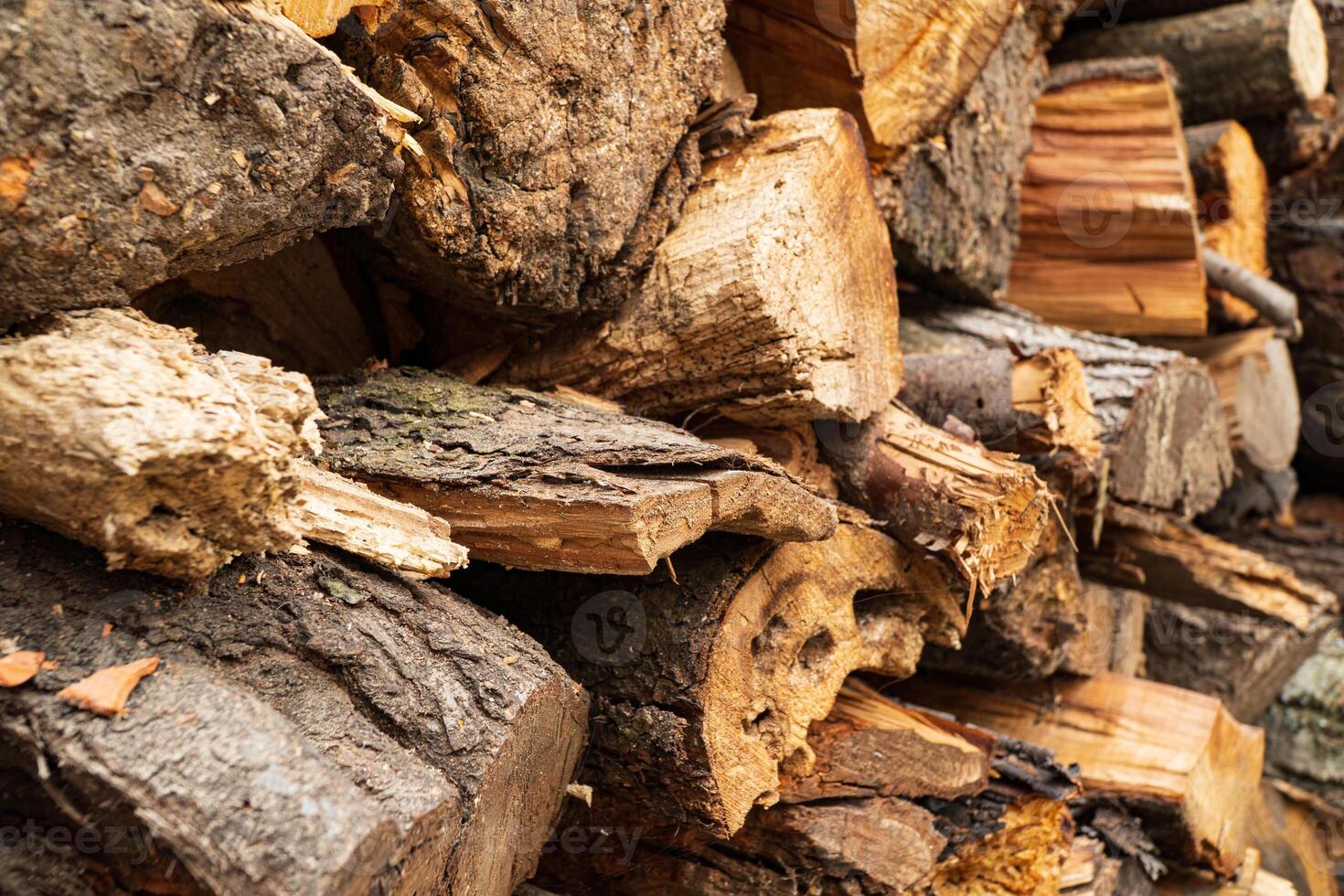 Chopped stacked firewood close up, soft focus photo