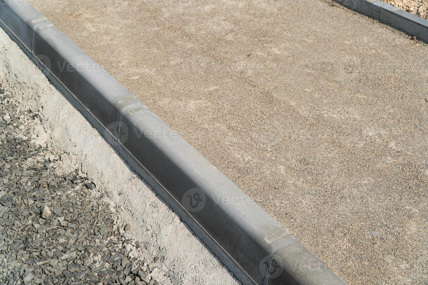 Construction of a pedestrian path. Paving of pedestrian paths on city streets. Road curbs and sidewalks photo