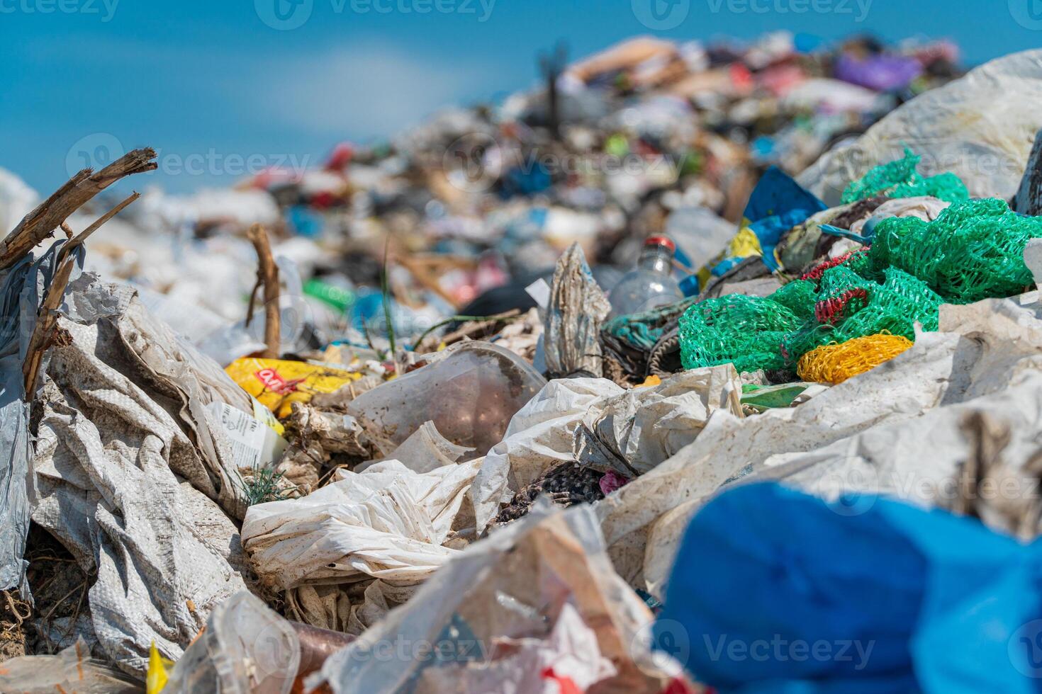 Pile of domestic garbage in landfill. Plastic scrap in landfill. Plastic and polyethylene waste photo