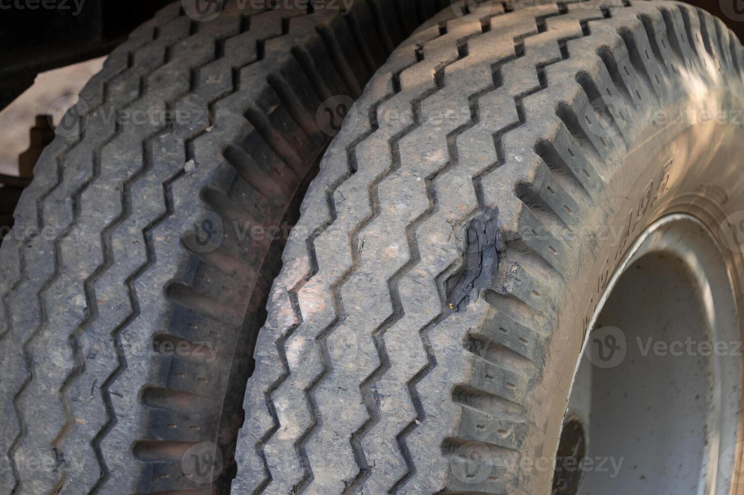 Inspecting worn truck tires workshop maintenance image indoor close-up vehicle safety photo