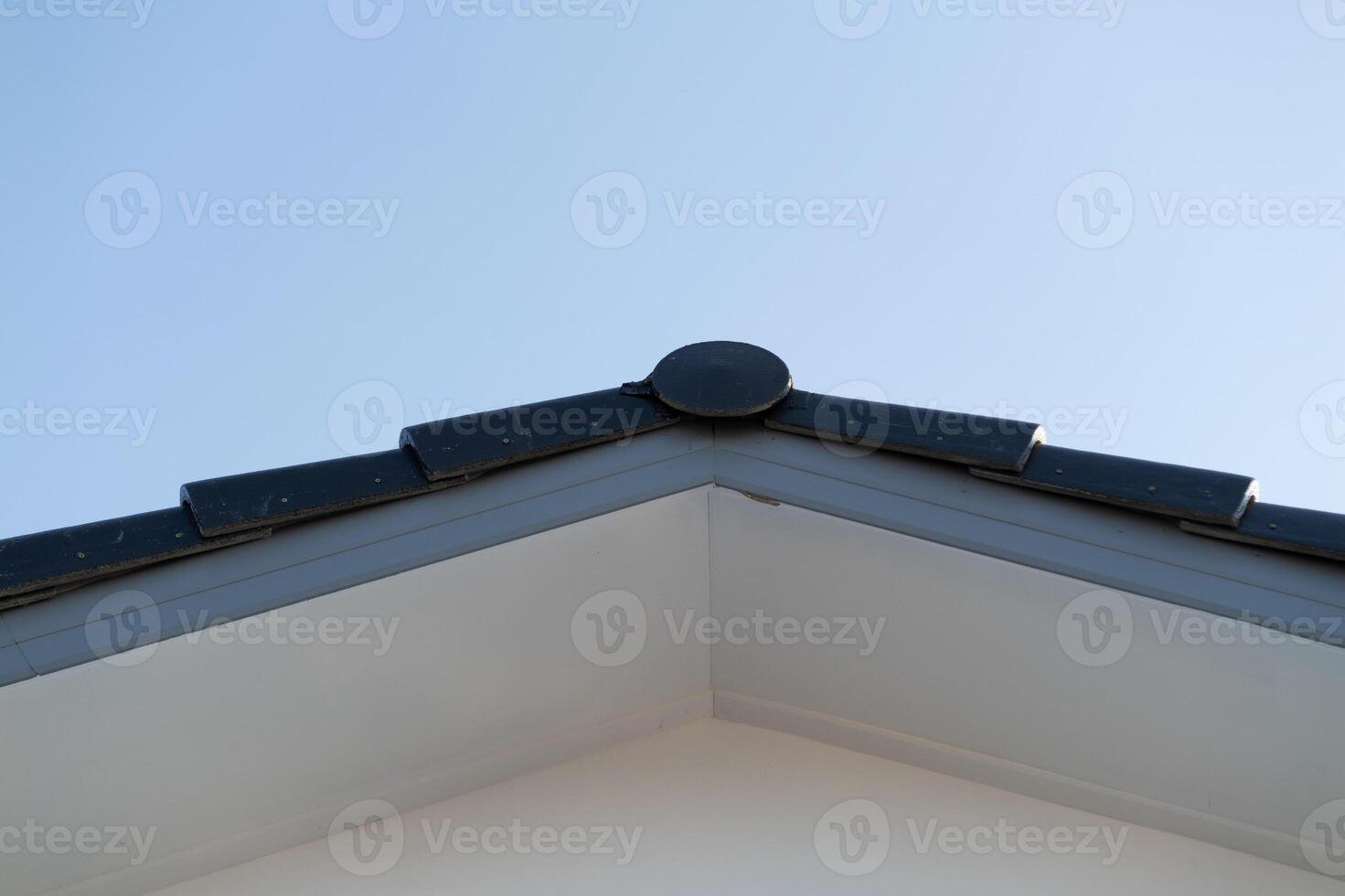 Roof edge detail traditional architecture minimalist style bright sky low angle geometric lines for aesthetic appeal photo