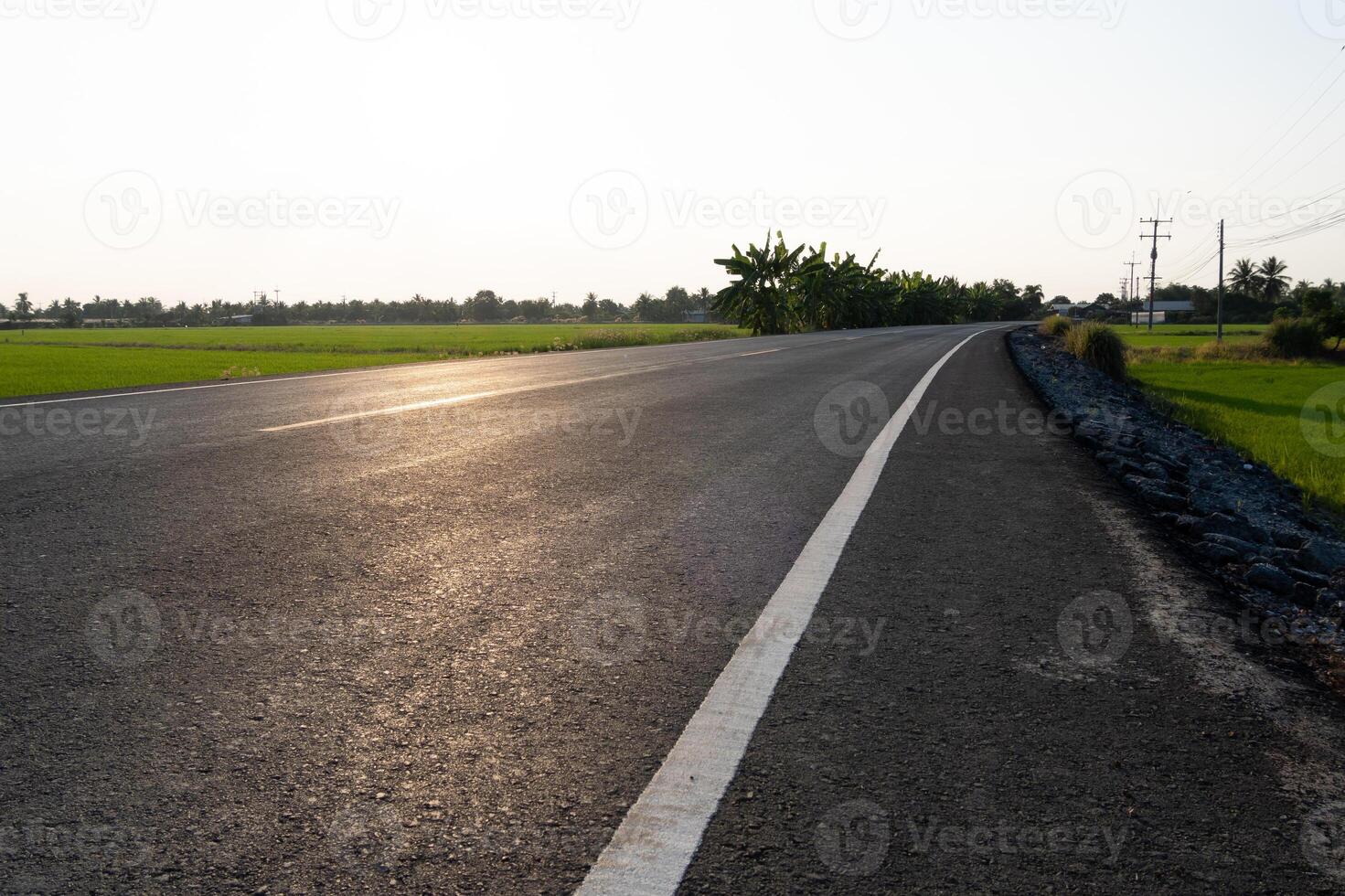 Photography of a curved road rural landscape road scene early morning wide angle journey concept photo