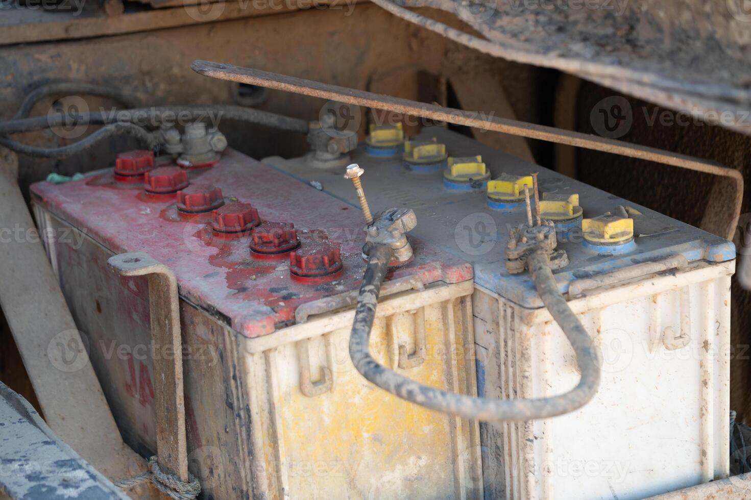 Inspecting heavy machinery battery construction site close-up image industrial environment overhead view maintenance insight photo