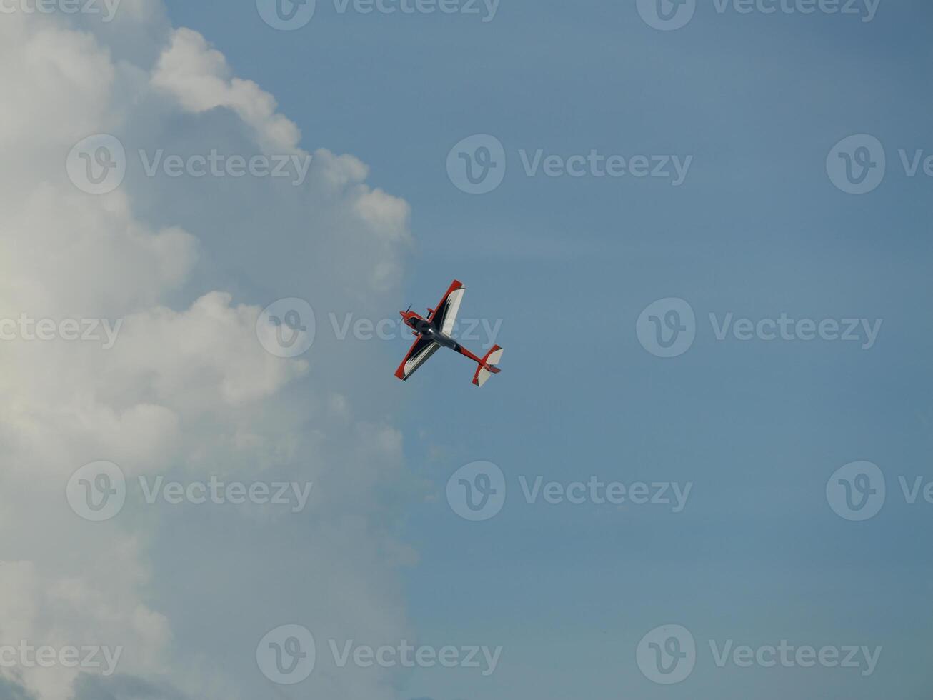 Aerobatic maneuvers by a stunt plane sky above aerial photography cloudy environment elevated viewpoint aviation concept for enthusiasts photo